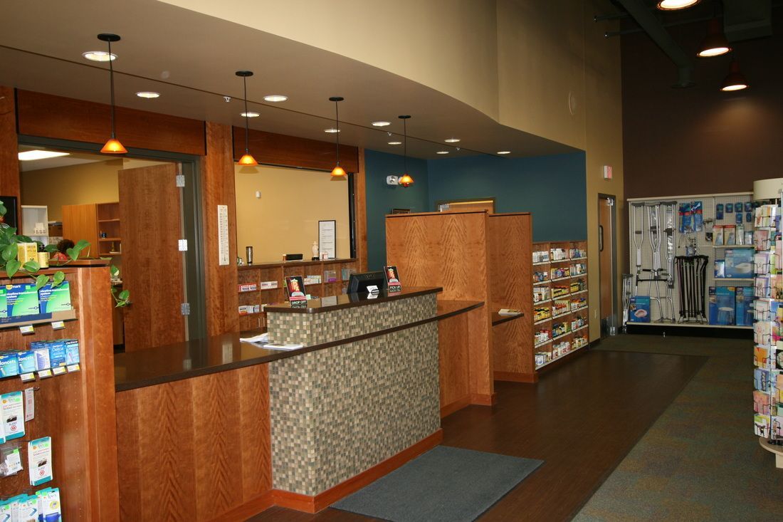 The inside of a pharmacy with a counter and shelves