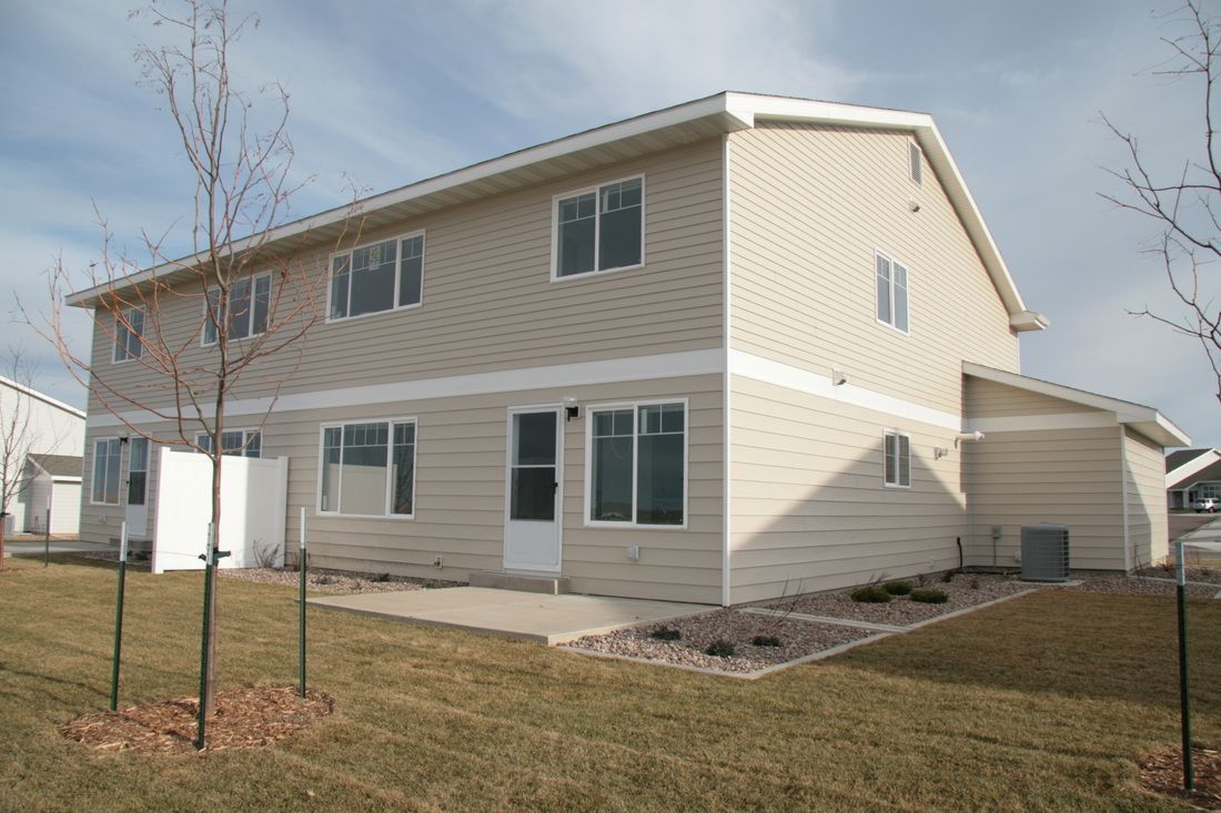 A house with a lot of windows and a white door