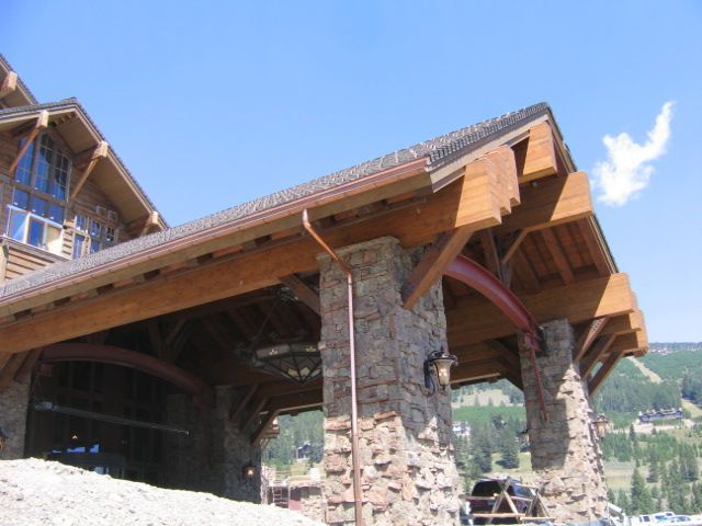 A large building with a wooden roof and stone pillars