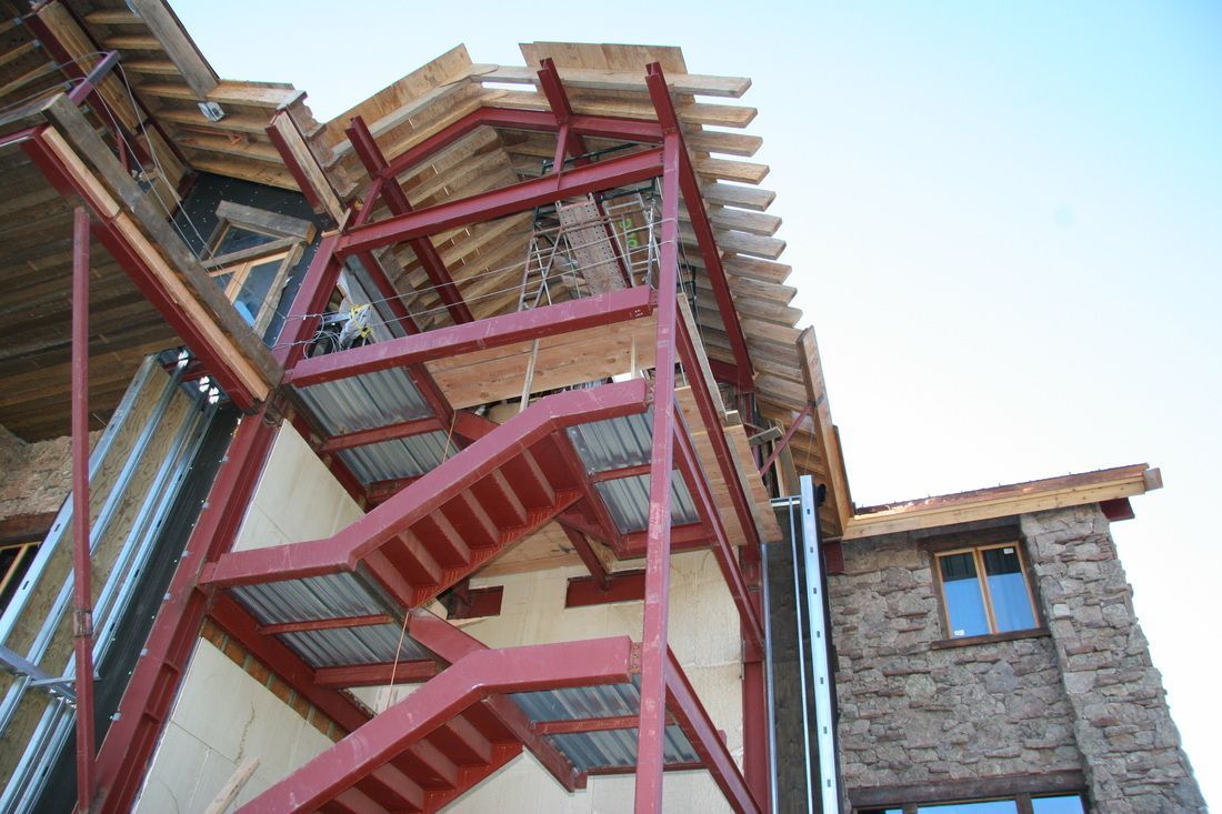 A fire escape is being built on the side of a building