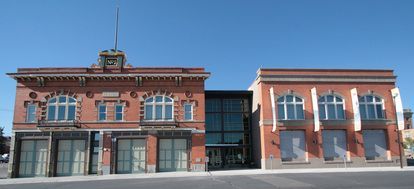 A brick building with a clock on top of it