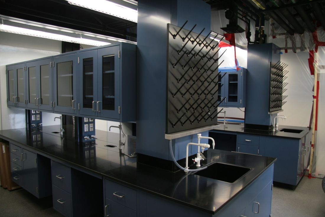 A kitchen with blue cabinets and a sink