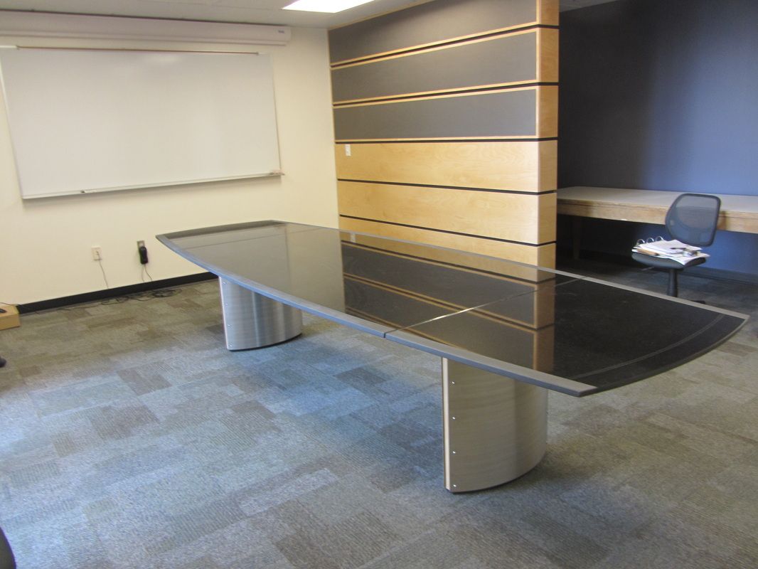 A conference room with a long table and a chair