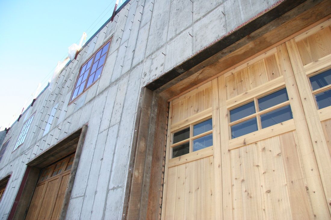 A close up of a wooden garage door on a building.