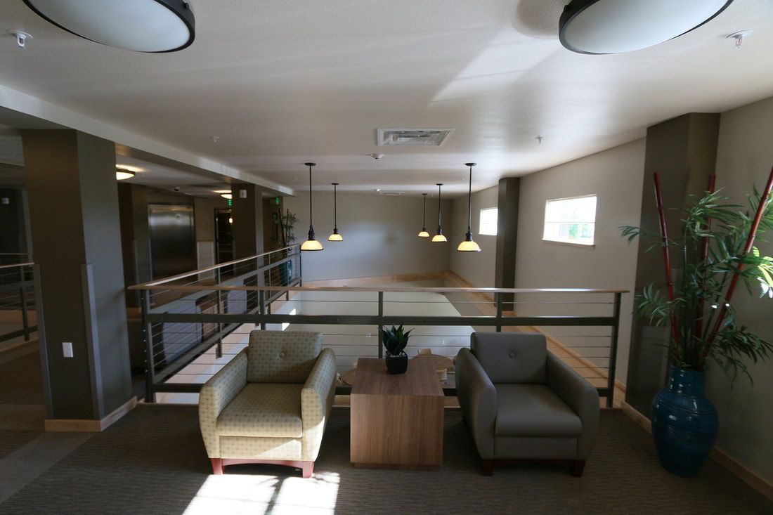 A living room with two chairs and a table