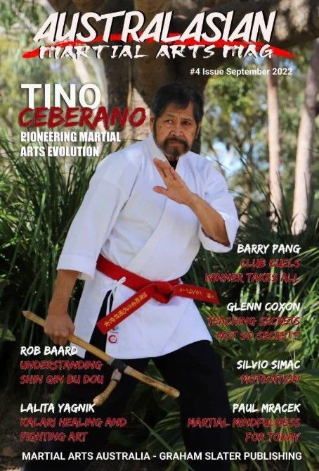 Martial arts magazine cover with a man in a white gi and red belt posing in front of bamboo trees