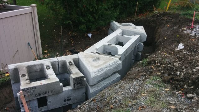 A pile of concrete blocks sitting on top of a pile of dirt.