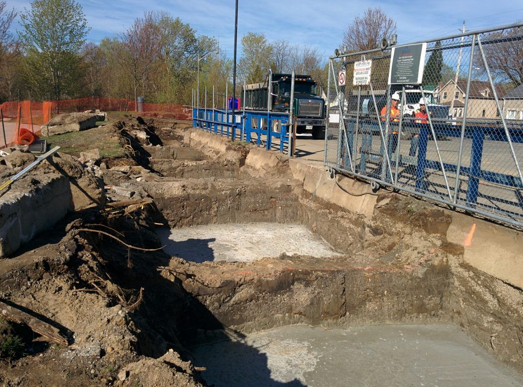 A construction site with a lot of dirt and concrete
