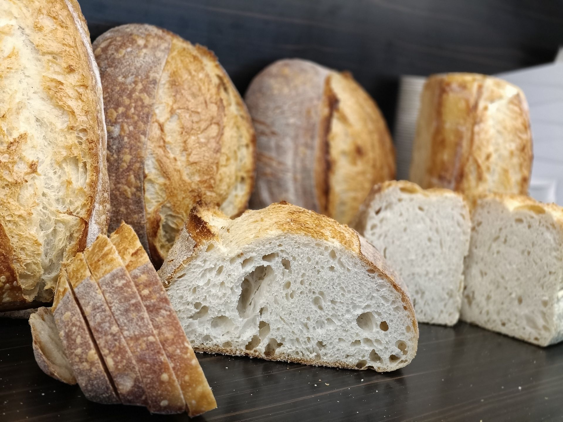 Various Loaves of Crusty Bread, Some Sliced, Showcasing Textures — Atherton Bakehouse in Atherton, QLD