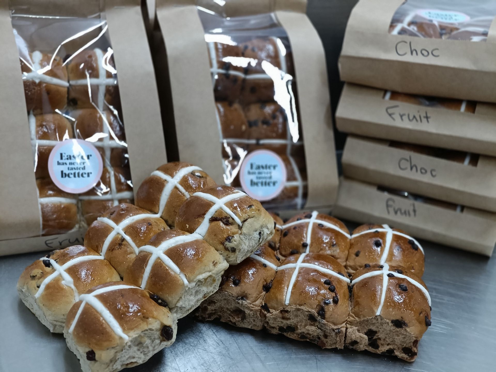 Hot cross buns, some in bags with labels: