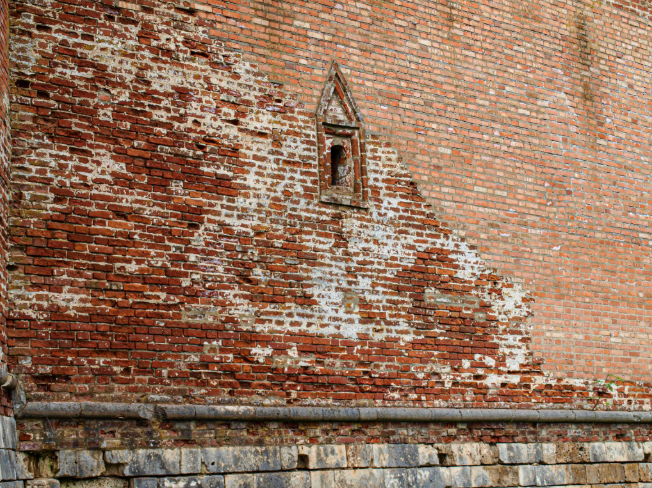 “Weathered brick wall with worn surface areas showing where repair and restoration may be needed during a masonry service in Pearland, TX”
