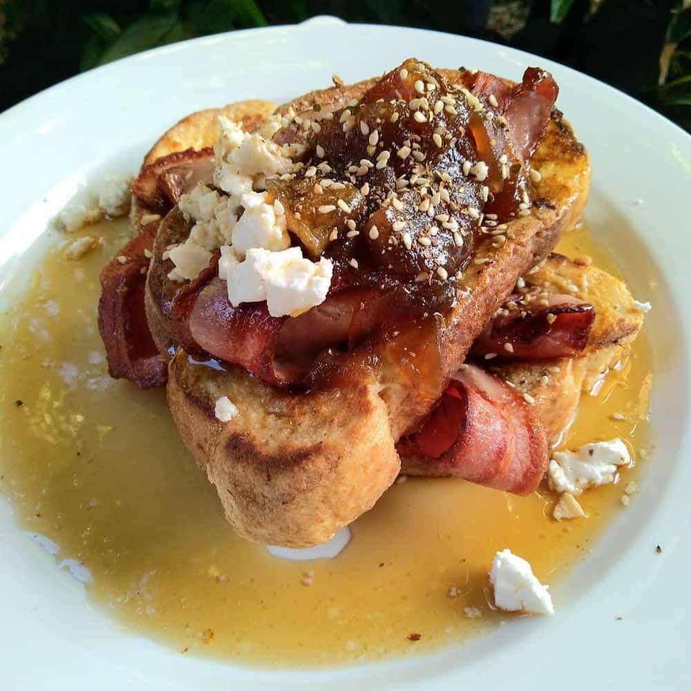 A White Plate Topped With French Toast Bacon And Cheese — Vines at 139 in Grafton, NSW