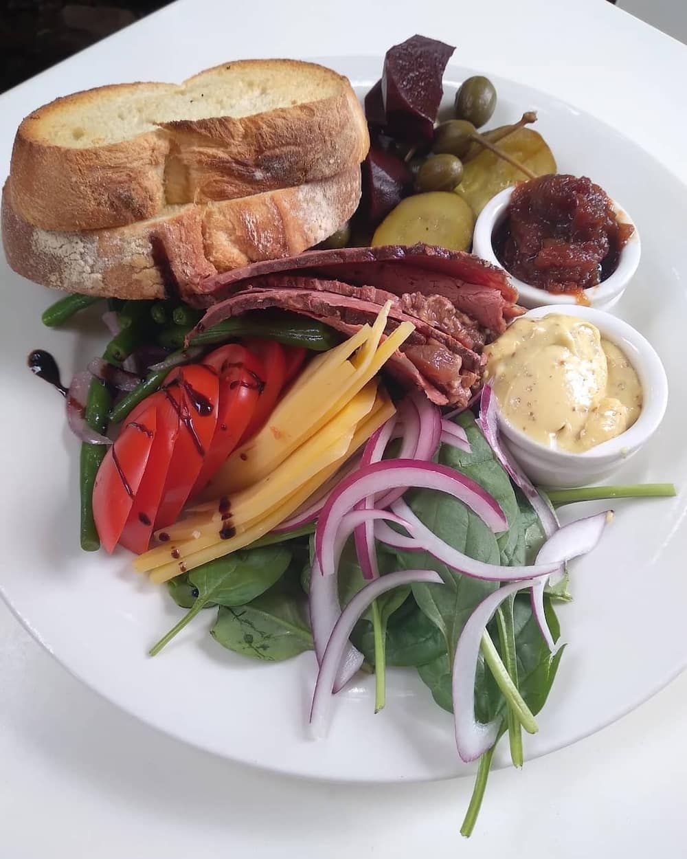 A White Plate Topped With A Sandwich And Vegetables — Vines at 139 in Grafton, NSW