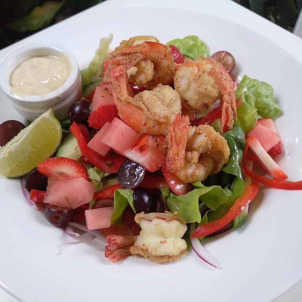A Salad With Shrimp And Vegetables On A White Plate — Vines at 139 in Grafton, NSW