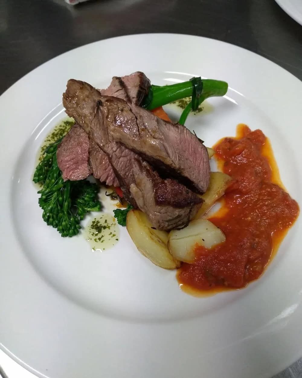 A White Plate Topped With Meat Vegetables And Sauce — Vines at 139 in Grafton, NSW
