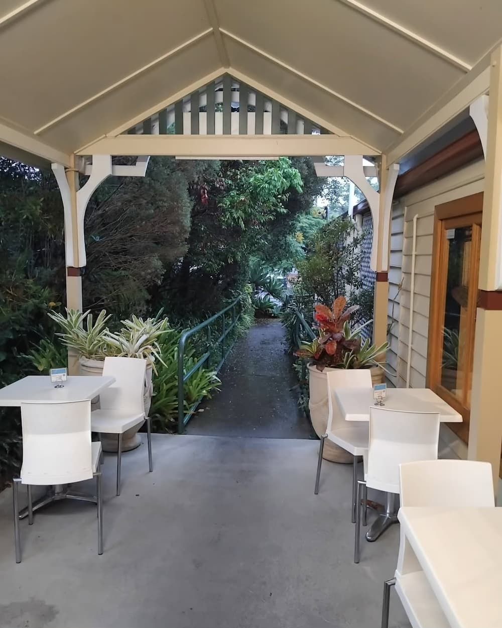 A Patio With Tables And Chairs Under A Canopy — Vines at 139 in Grafton, NSW