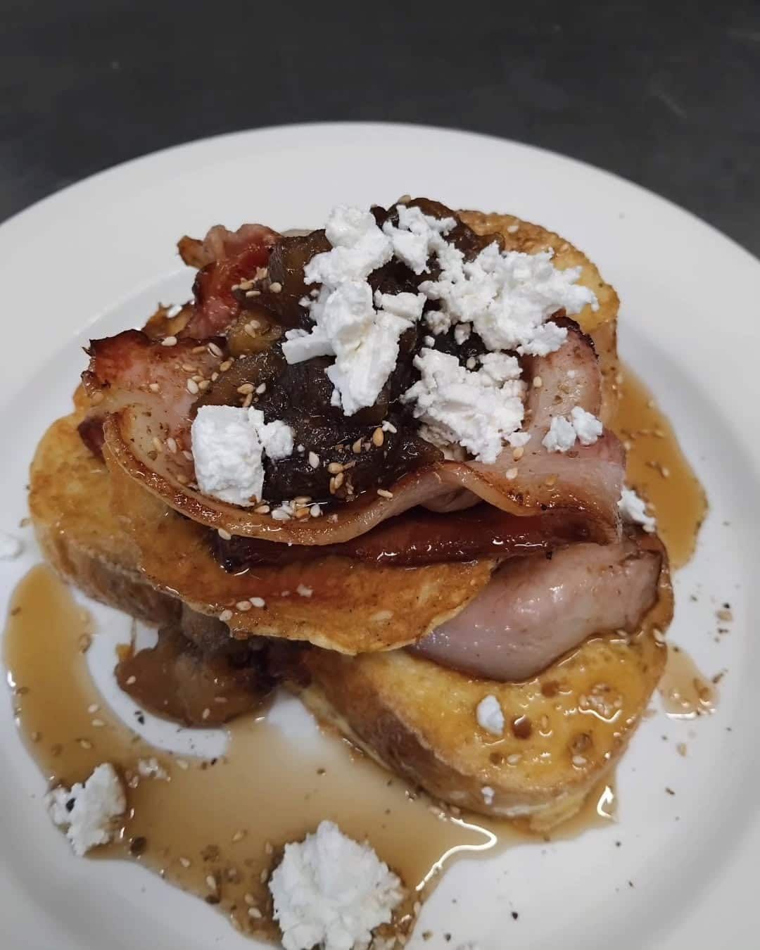 A White Plate Topped With French Toast Bacon And Whipped Cream — Vines at 139 in Grafton, NSW
