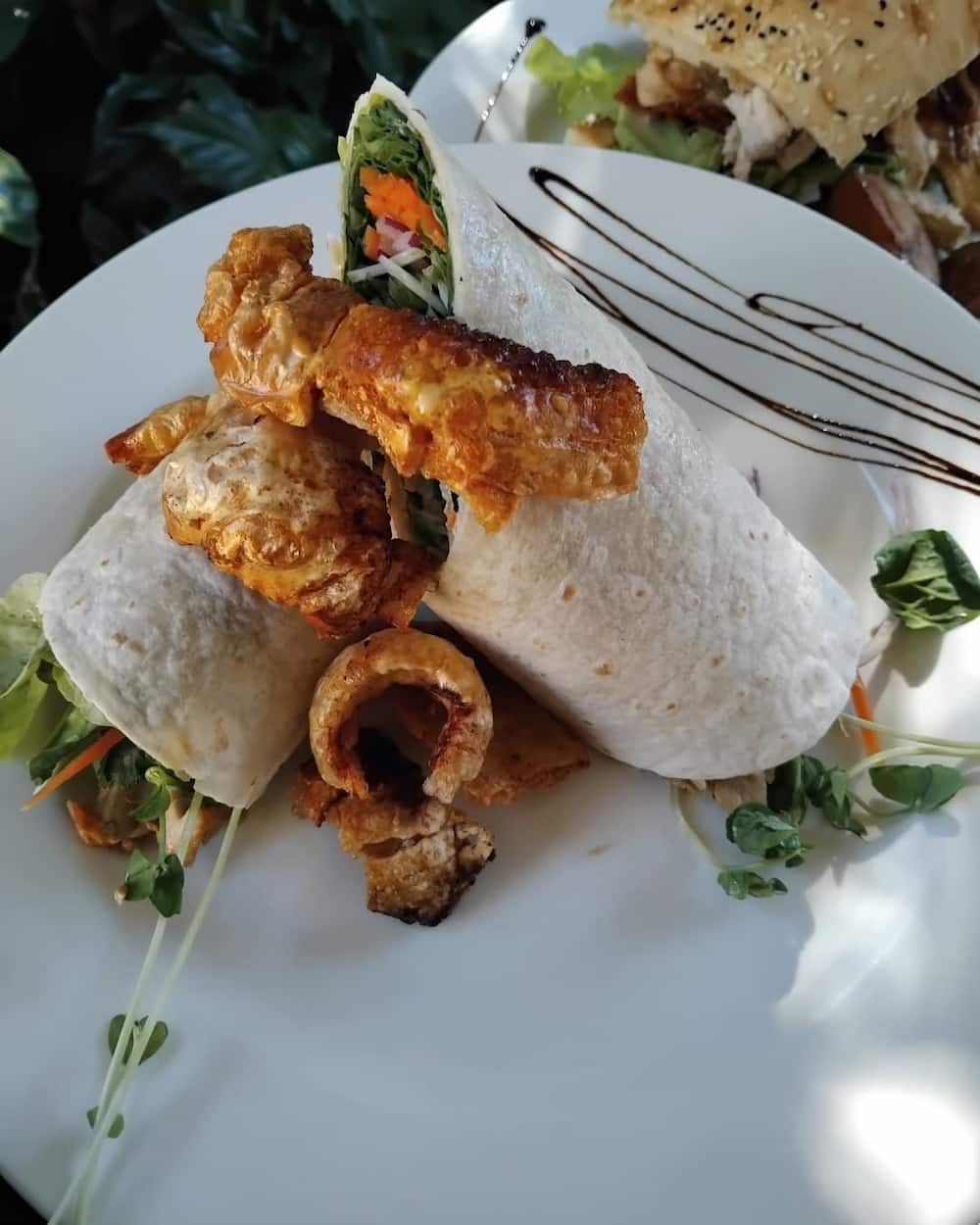 A White Plate Topped With A Wrap And A Fork — Vines at 139 in Grafton, NSW