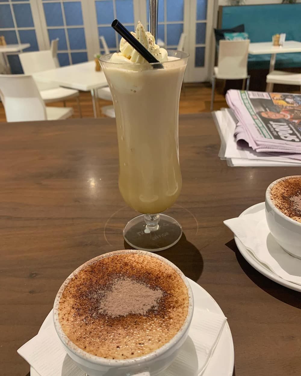 A Milkshake And A Cup Of Coffee Are On A Table — Vines at 139 in Grafton, NSW