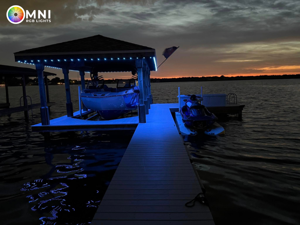 Blue-lit boat dock with a canopy-covered boat at sunset over calm water