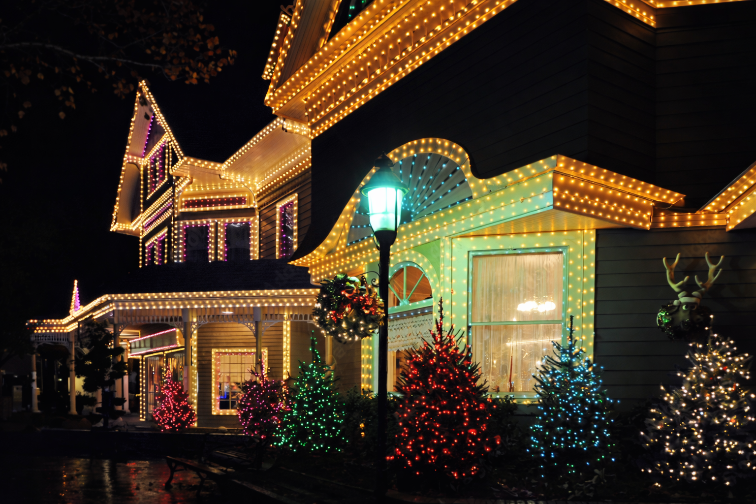 House covered in colorful holiday lights at night