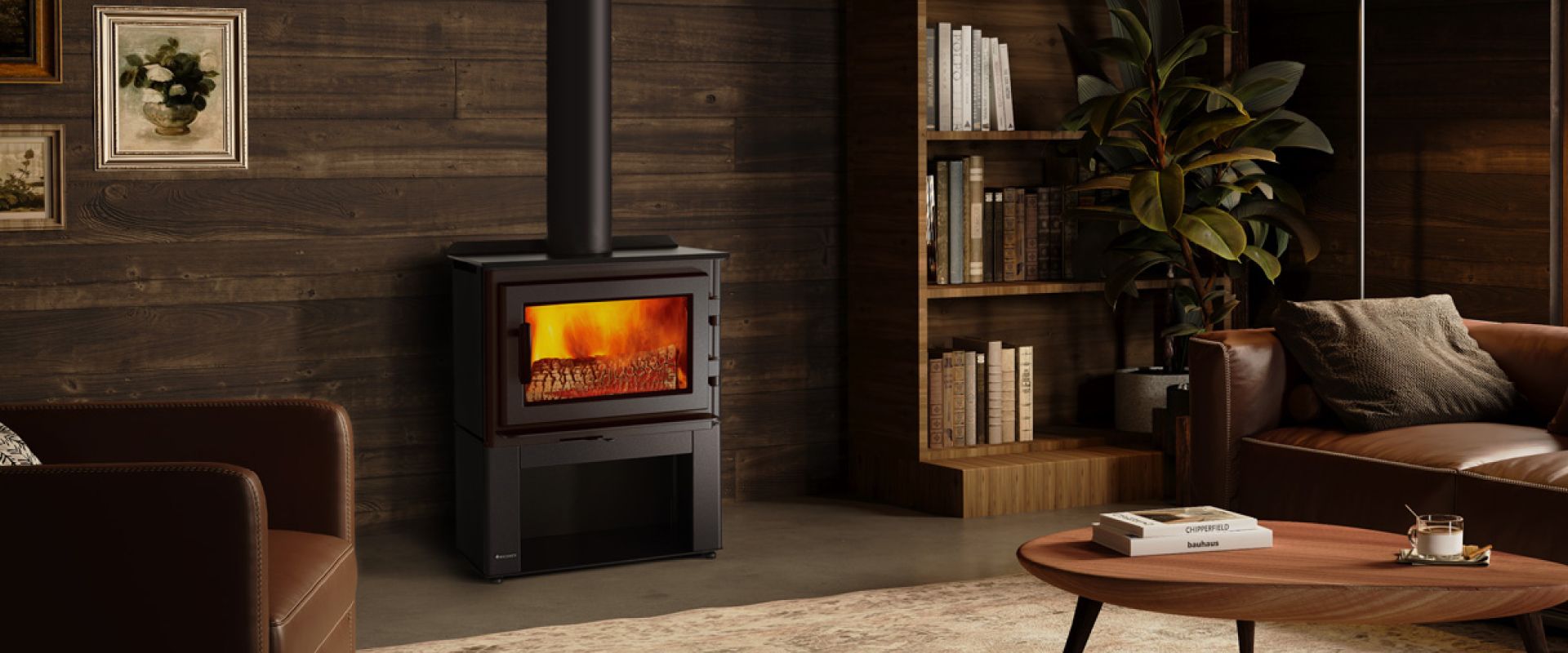 Cozy living room with a lit wood stove, brown sofa, bookshelf, and coffee table