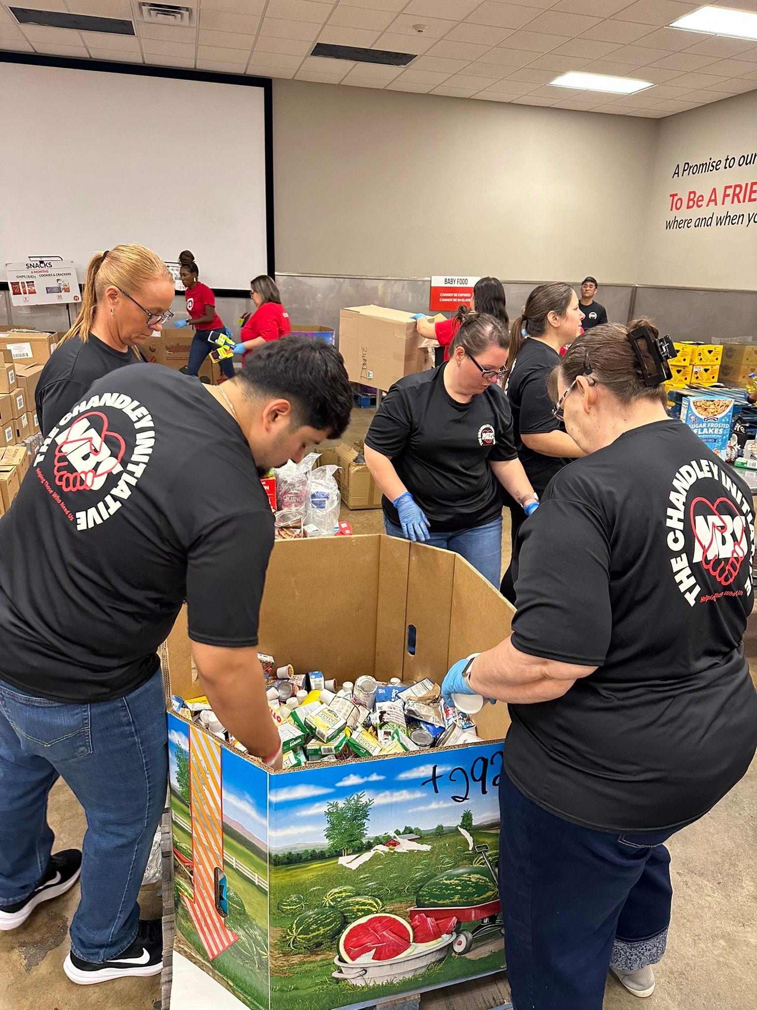 Volunteers sorting donated goods into boxes at a community distribution event