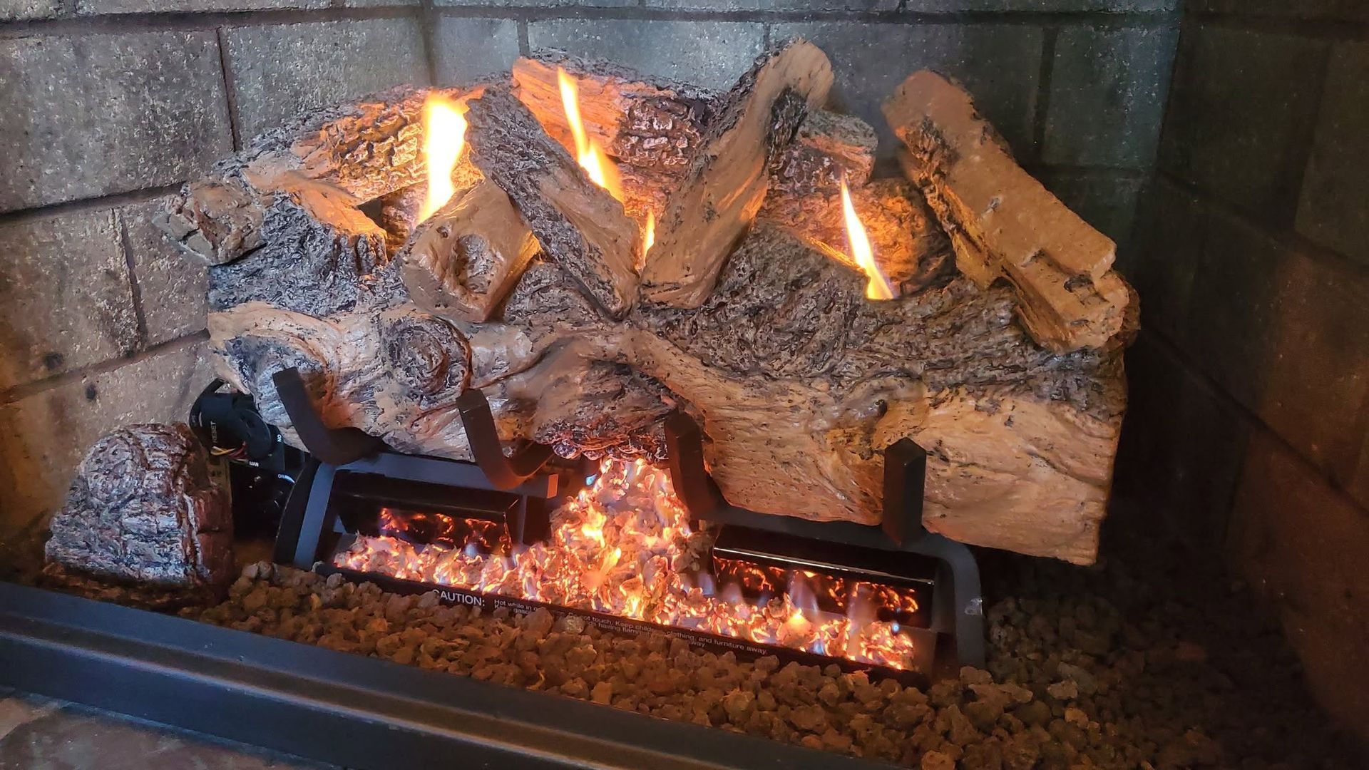 Logs with fire fueled by propane.