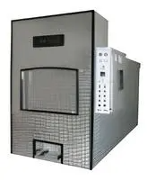 Large gray industrial machine with a front door and side control panel