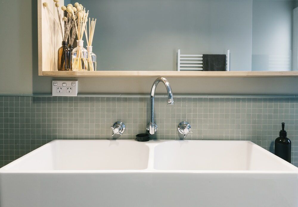 A Bathroom Sink With a Faucet and a Mirror Above It — Offcut Carpentry In Murwillumbah, NSW