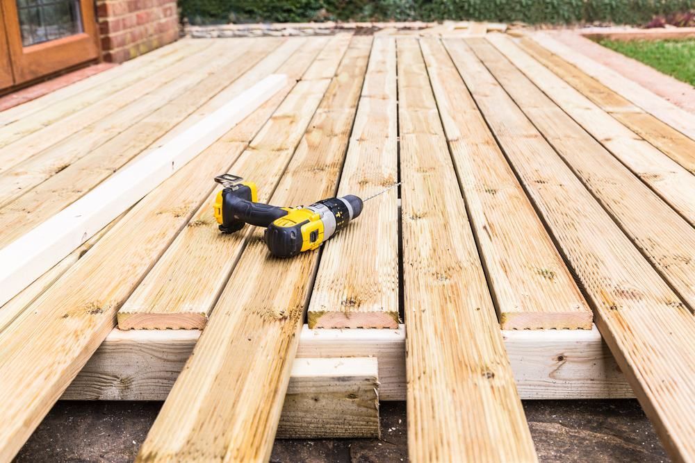 A Drill is Sitting on Top of a Wooden Deck — Offcut Carpentry In Murwillumbah, NSW