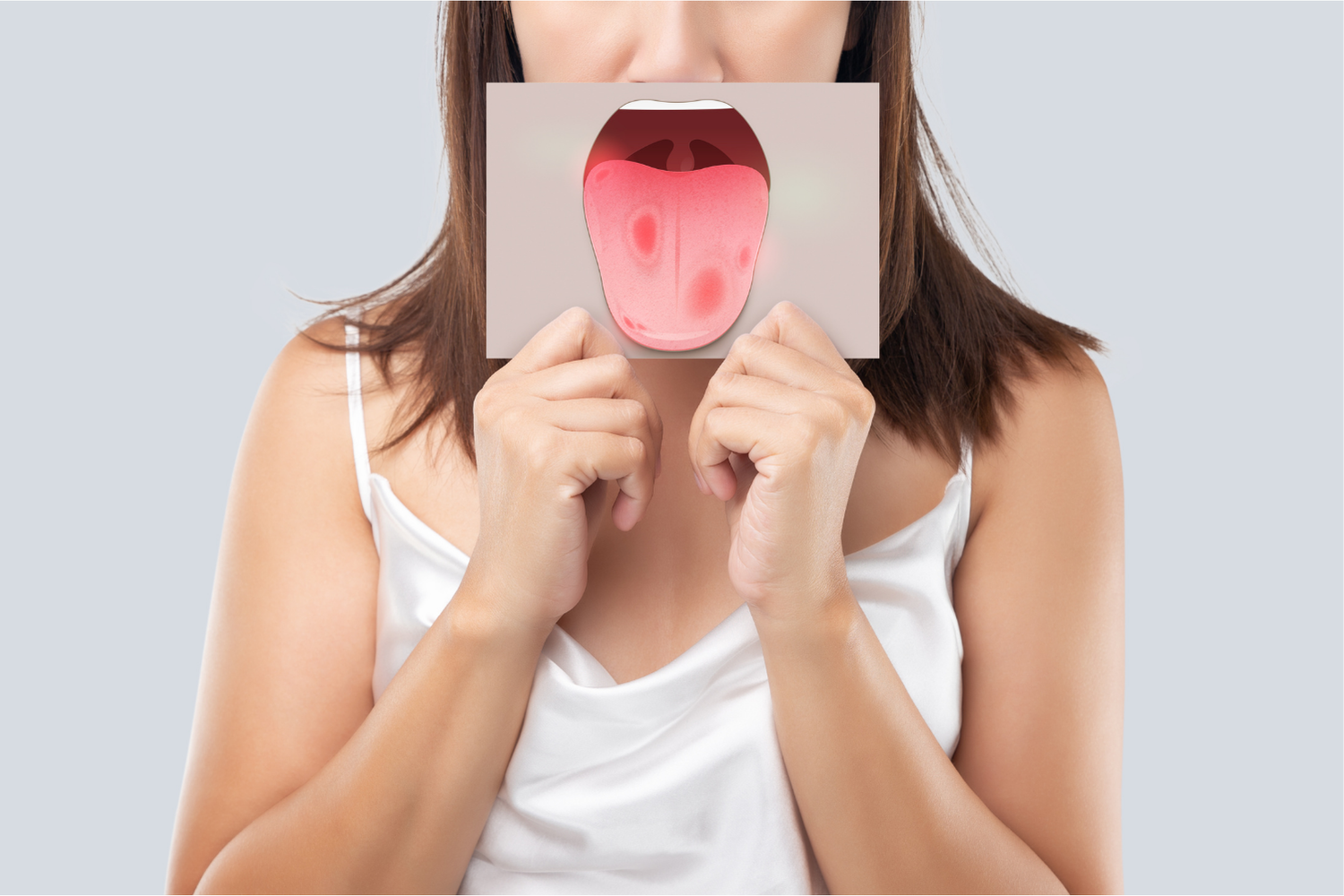 Woman holding a card with a drawing of an open mouth over her face