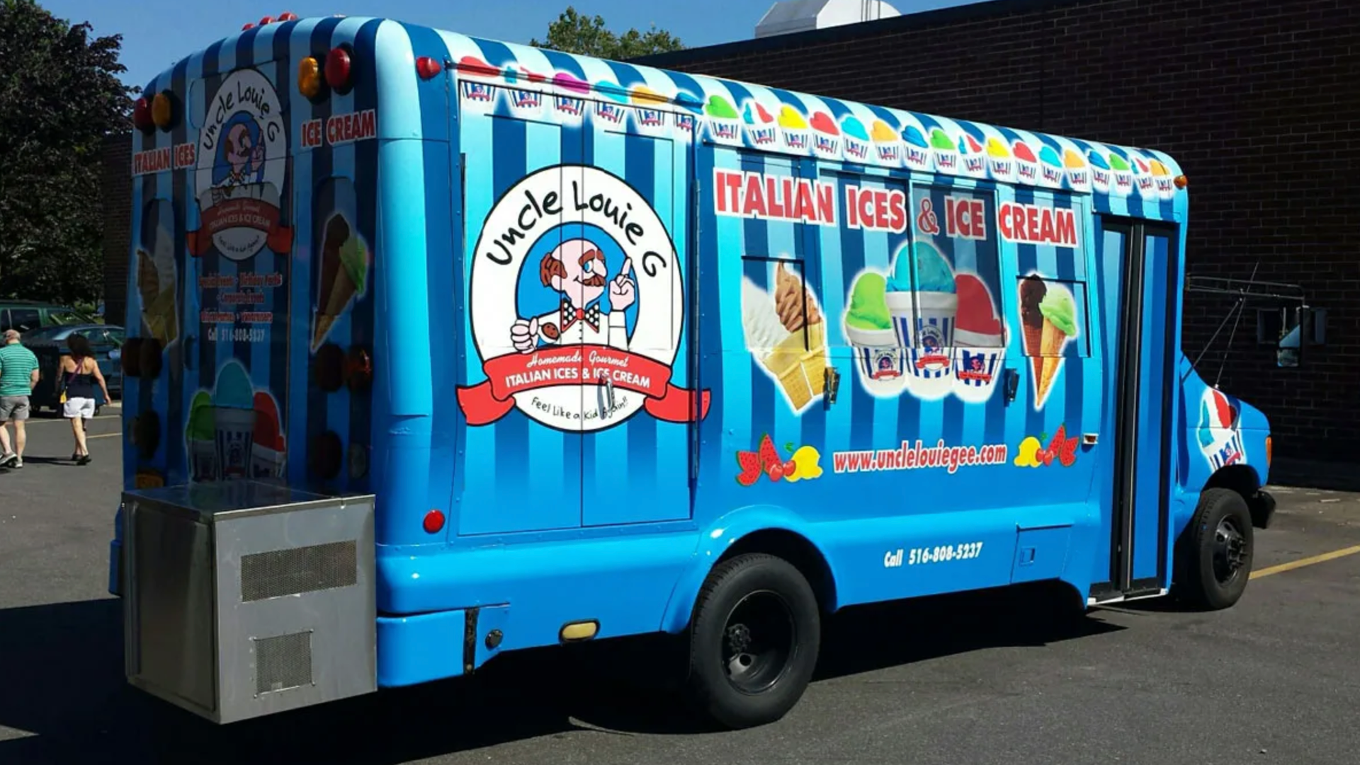 Blue Uncle Louie C ice cream truck with colorful illustrations, parked outdoors.