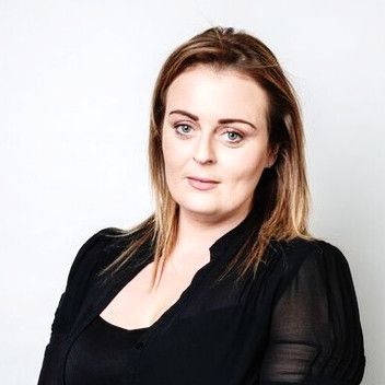 Portrait of a woman in a black top against a white background