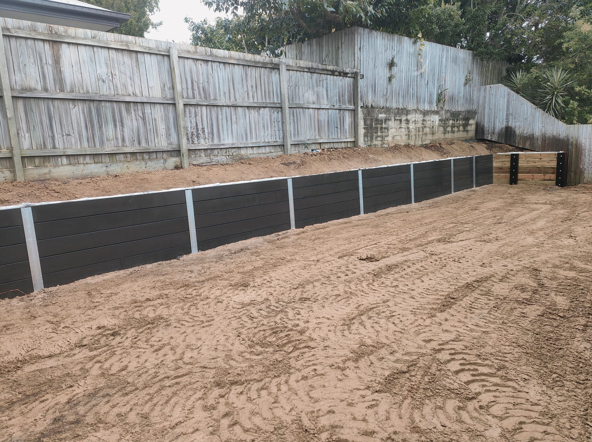 Raised Garden Bed Edging Along A Sandy Backyard Fence Line — Quality Fences 4 U in Gympie, QLD