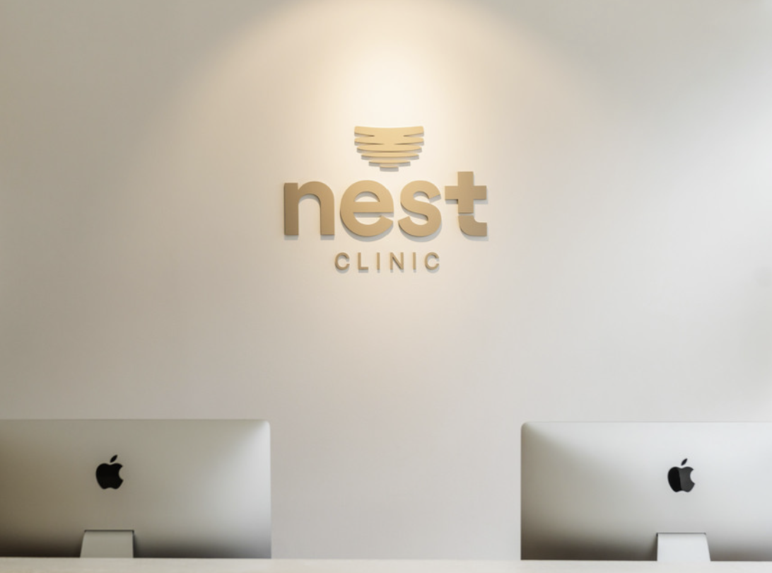 Nest Clinic logo wall in the beige reception area, Gangnam Seoul