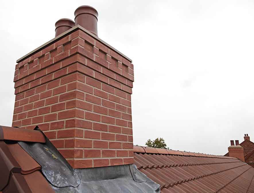 Brick chimney with two chutes sitting atop shingled roof – Macungie, PA - Anytime Todd's Chimney Sweeping