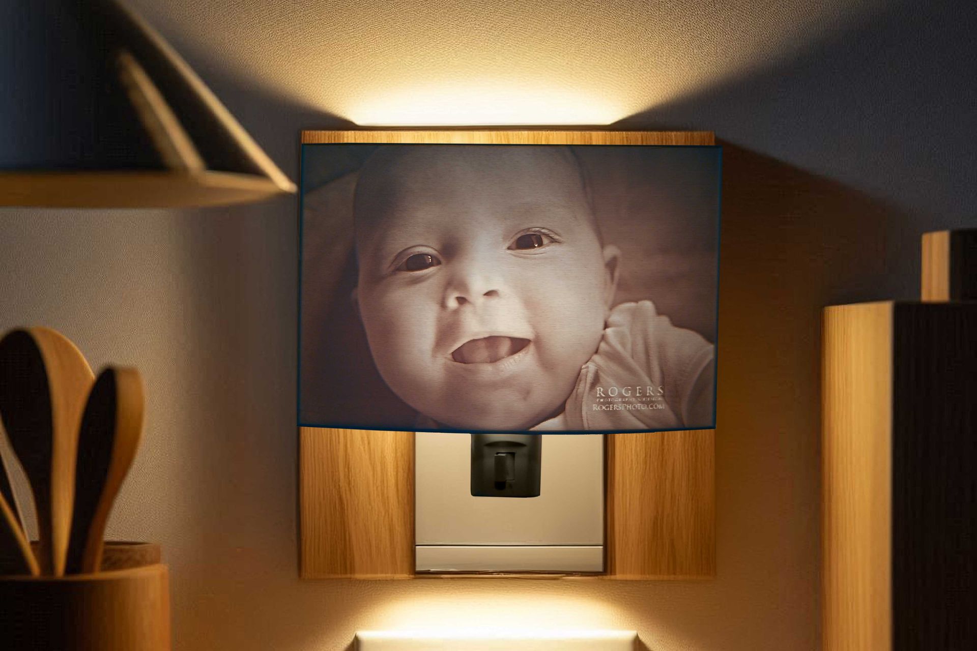 Baby portrait in a wooden wall niche, softly lit against a warm background.