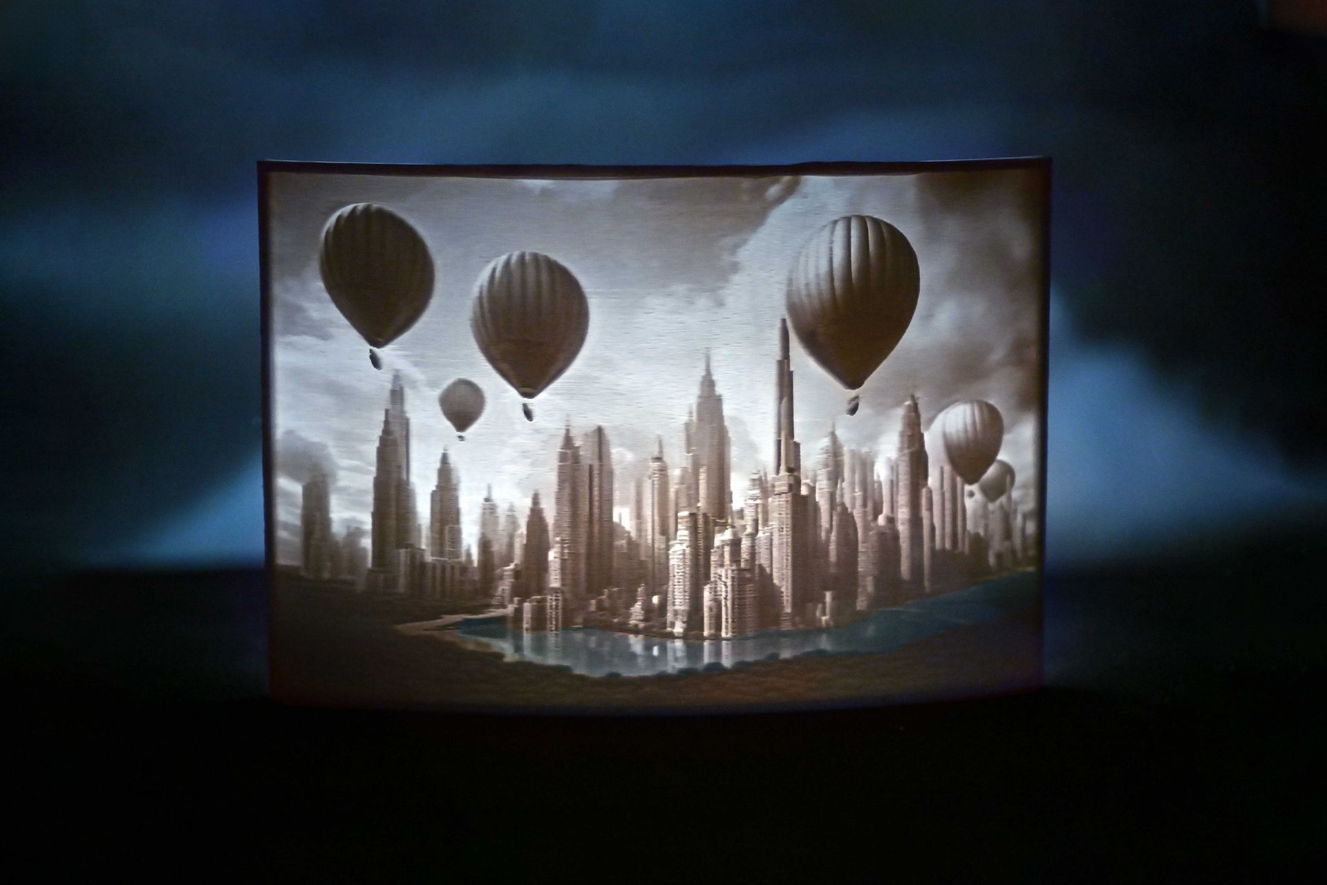 Sepia skyline with hot air balloons over a futuristic city, framed in a dark rectangular display