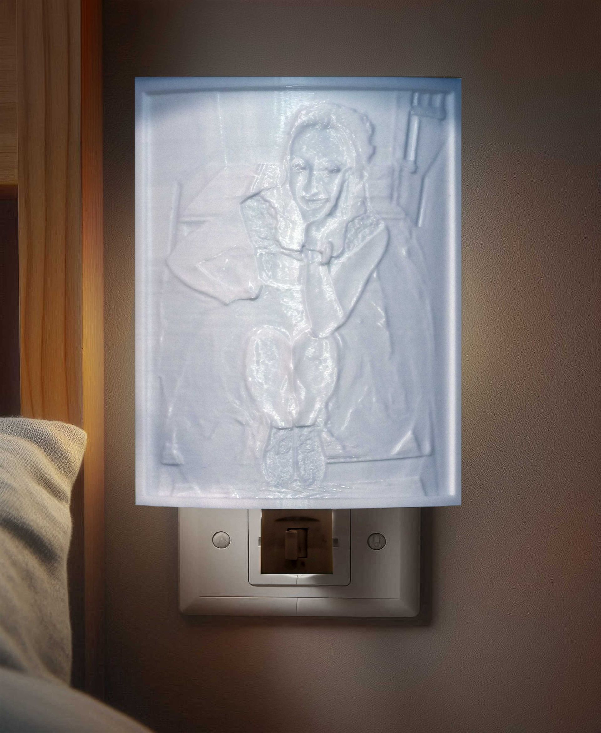 Rectangular white wall sconce with an embossed frosted panel glowing over a light switch.