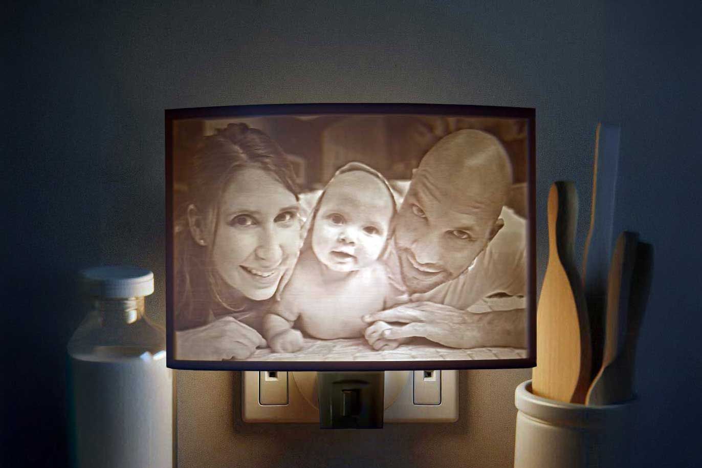 Framed family portrait lit on a wall between a glass jar and wooden utensils in a dim room