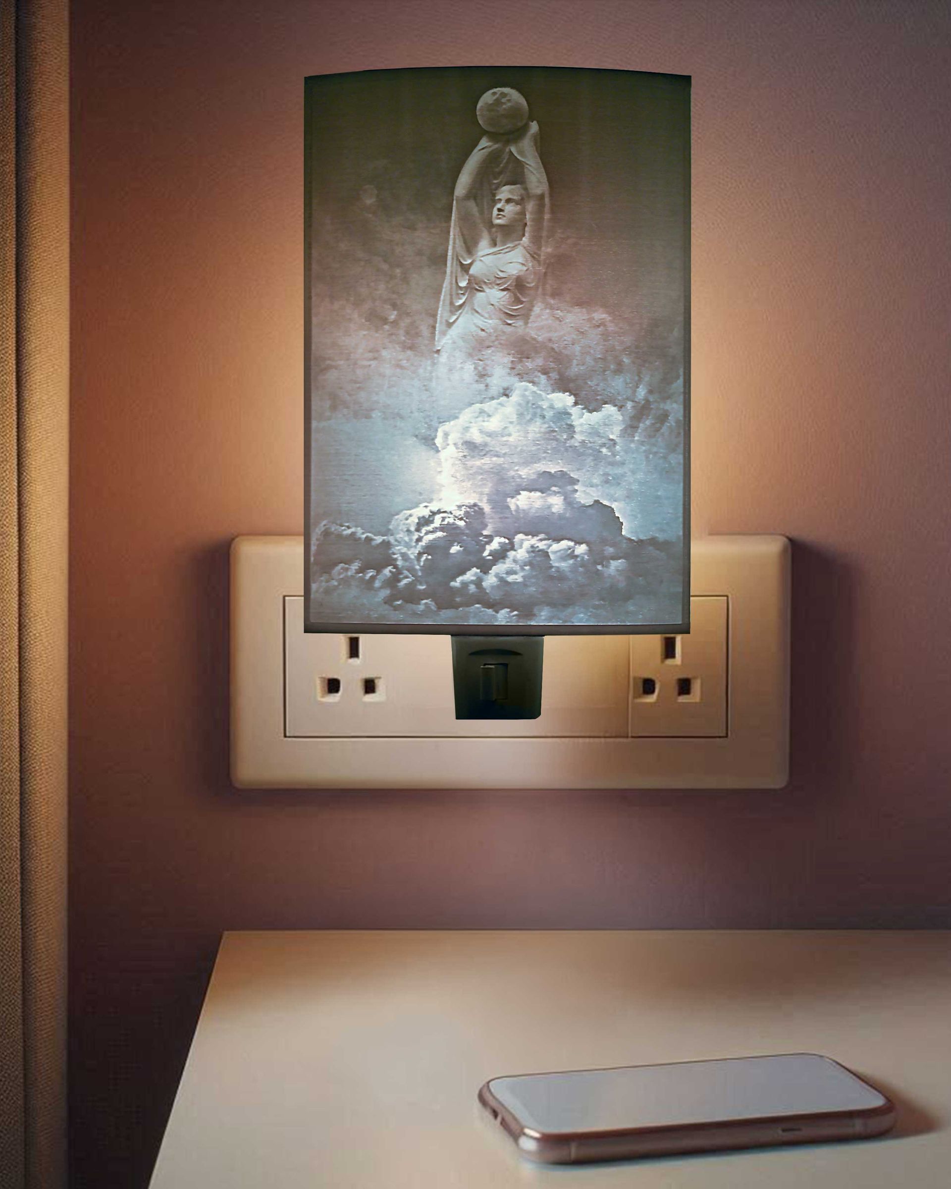 Wall outlet cover with a glowing sky-like design above a bed or table holding a smartphone.