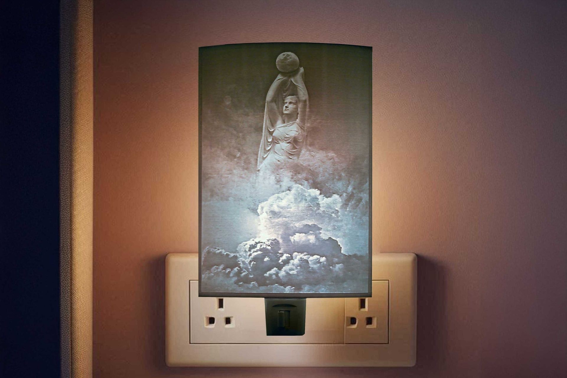 Nightlight with astronaut artwork plugged into a wall outlet above a beige switch plate