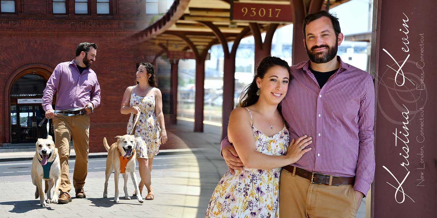 Engagement photos of Couple posing on a sidewalk with two dogs, brick building and people in the background