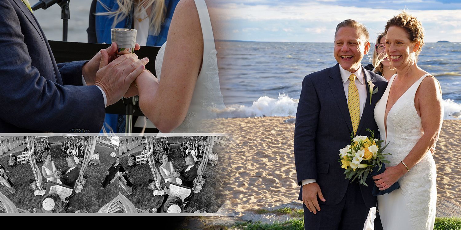 Wedding couple by the ocean with guests applauding, holding a bouquet and smiling in formal attire