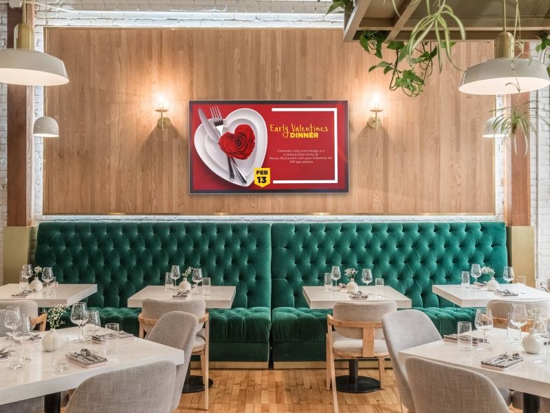 a restaurant with tables and chairs and a tv on the wall