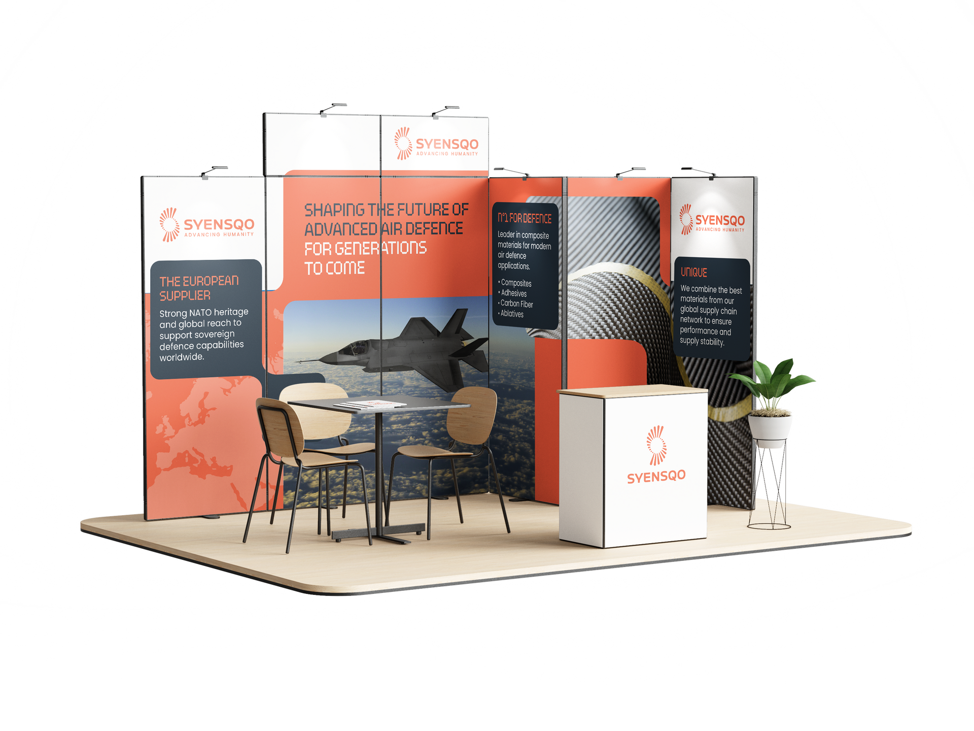 Modern trade show booth with orange and black panels, seating area, and display counters on a white platform