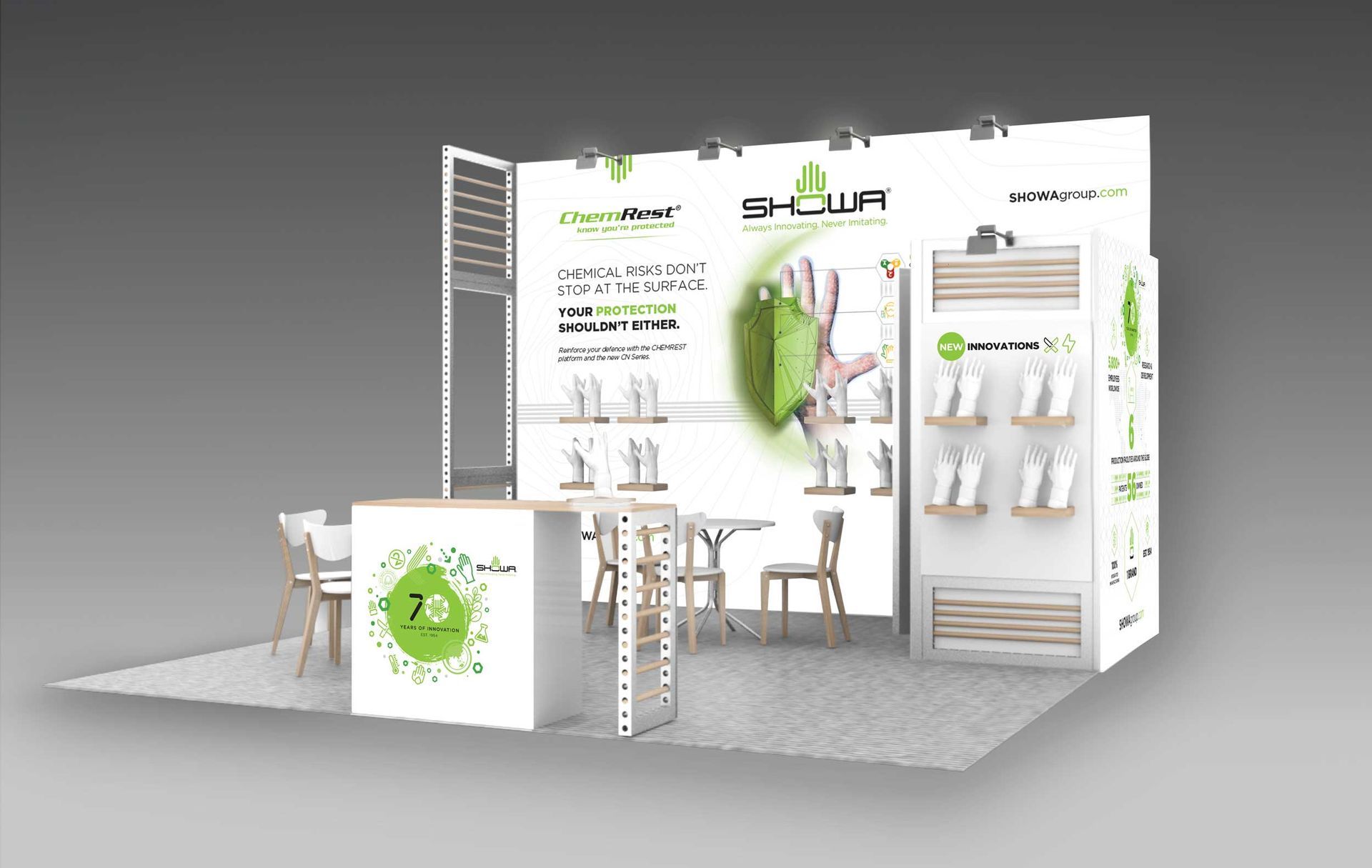 Trade show booth with white and green displays, product panels, tables, and stools on a gray floor.