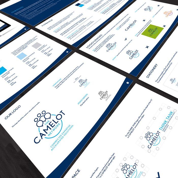a stack of camelot brochures on a table