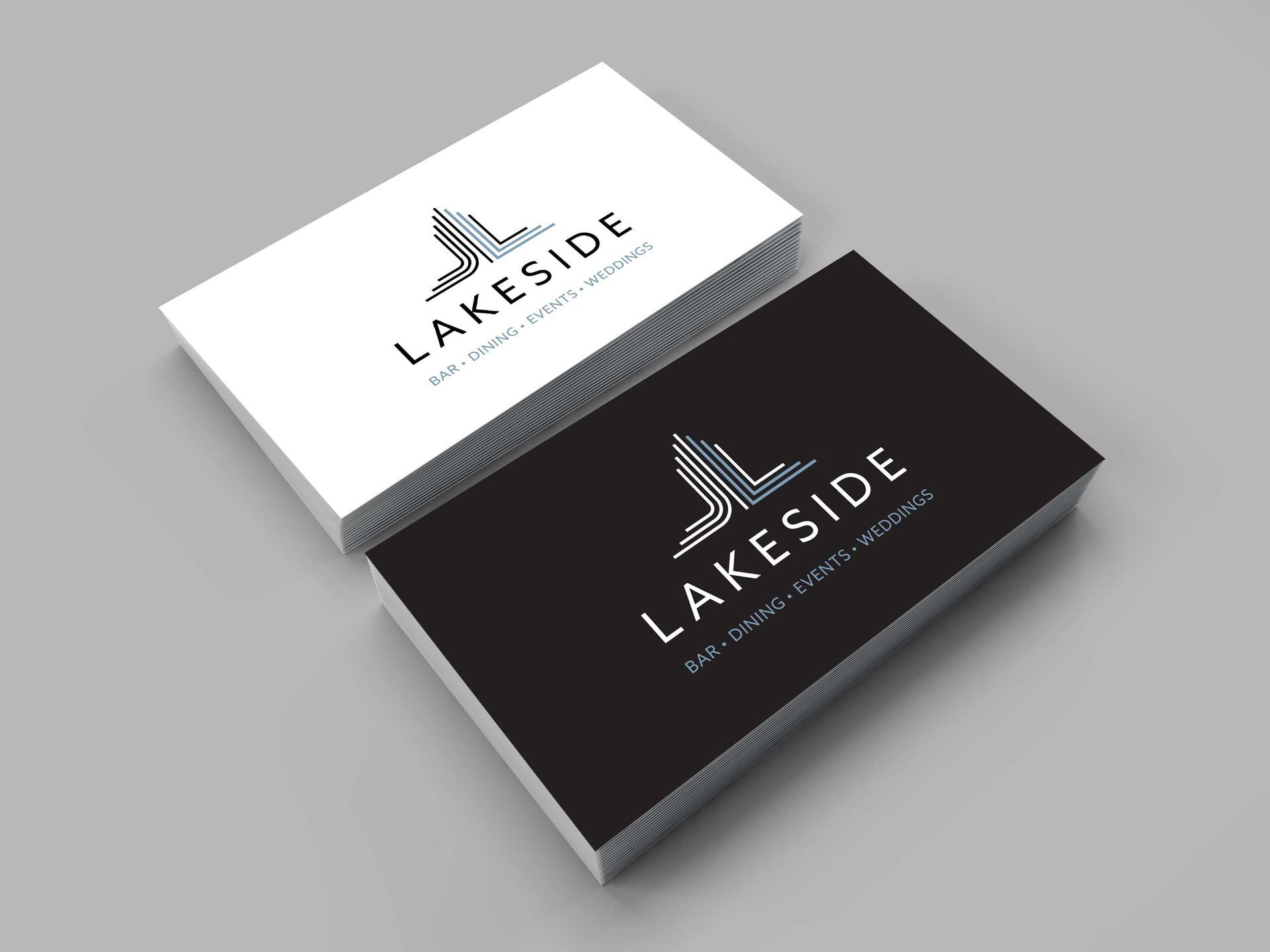 Two Lakeside business card mockups, one white and one black, with a tower logo.